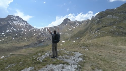 Hiker Celebrates Success Among Beautiful Mountains