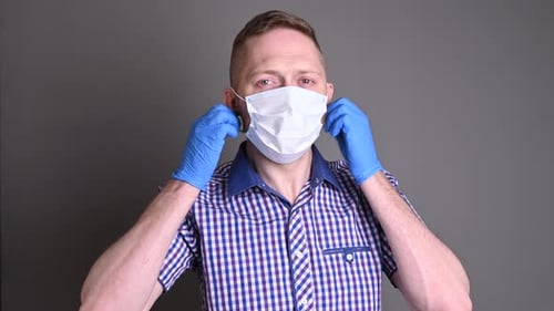 Adult Takes Off Medical Mask and Waves Hand