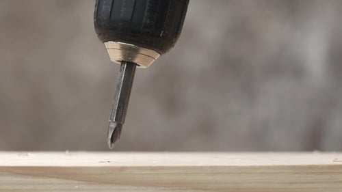 Screwing Screw Into Wooden Plank