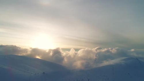 Snowy Mountains and Clouds at Sunrise