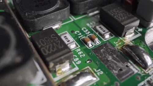 Extreme close-up of green Printed Circuit Board Electronics shot with dolly