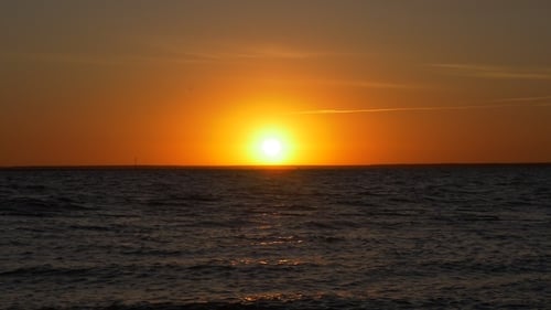 Sunrise Over the Sea on Beige Sky