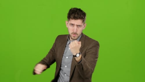 Man Is Standing in a Rack and Boxing. Green Screen