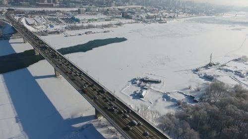 Quadcopter Flying Over a Highway Bridge Across the Ob River