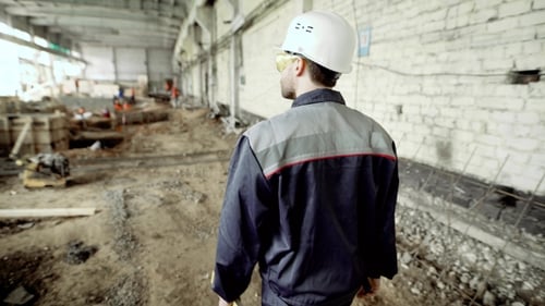 Back View of Construction Worker. Anonymous Man in Hard Hat and Uniform