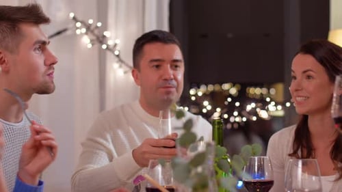Friends Toasting with Wine at Dinner Party