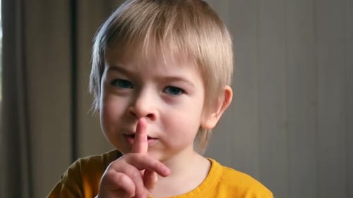 Boy with Finger on Lips