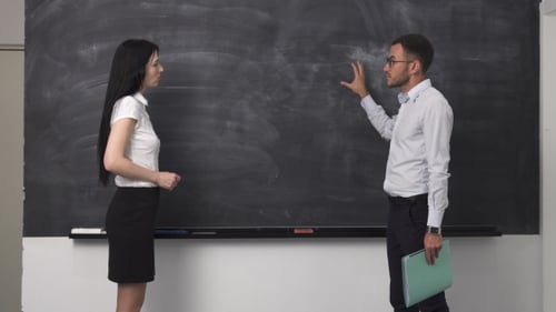 Business Professional Explaining Near Blackboard