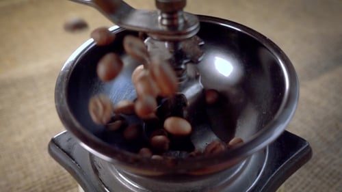 Coffee Beans Fall in the Old Grinder