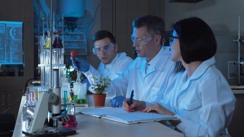 People Dripping Chemical in Plant