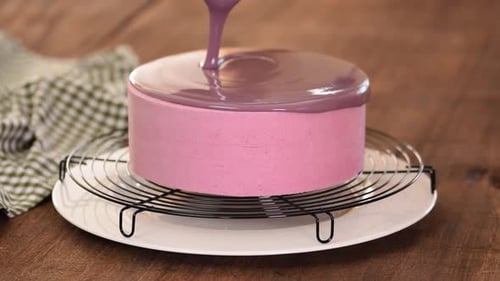 Close Up of Professional Chef Covering the Glaze Cake. Woman Decorating Cakes with Mirrored Glaze.