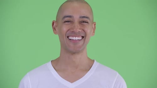 Bald Adult Smiling Cheerfully Against Green Background