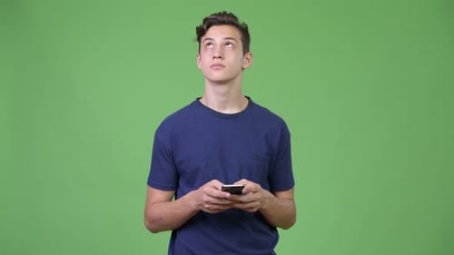 Teen Smiling While Using Mobile Phone