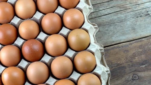 Carton of Eggs on Rustic Wood Table