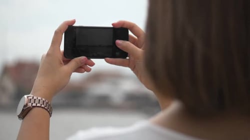 Woman Holding Smartphone Taking Pictures Outdoors