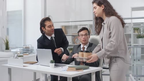 Business Team Receives Coffee in Bright Modern Office