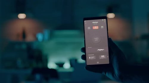 Close Up of Man Hand Holding Phone with Modern Software Controlling Lights