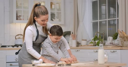 Mother and Child Baking Cookies Together at Home