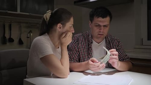 Couple Struggling With Finances at Home During Evening