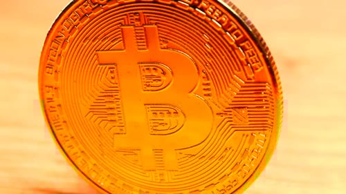 Close Up of Gold Bitcoin on Table