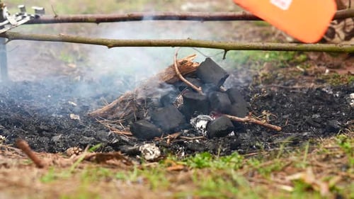 Man Making a Fire in the Forest