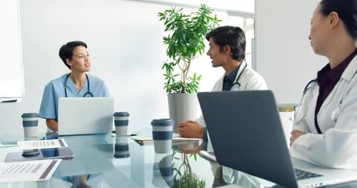 Medical Professionals Discussing at Conference Table