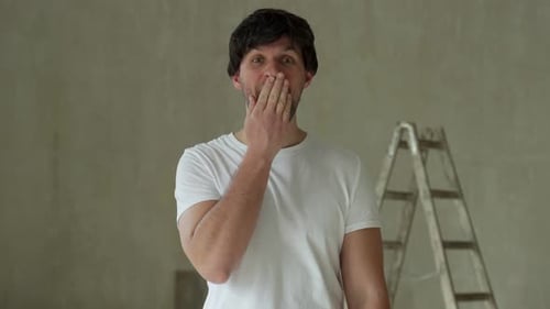 Surprised Man Smiling in Bright Indoor Setting