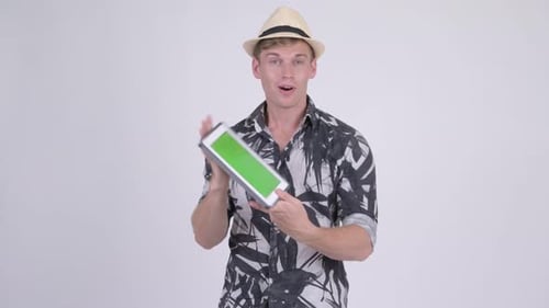 Man Holds Tablet with Green Screen Display