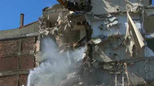 Building Demolition with Excavator and Water Spray