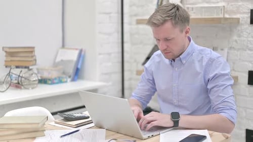 Businessman Working on Laptop in Office