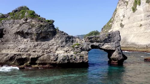 Atuh Beach natural arch in Nusa Penida island, Aerial approach shot
