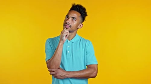 Man Thinking and Pondering on Yellow Background