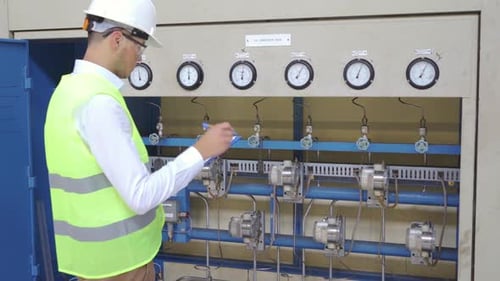 Engineer checking transducer rack at factory.