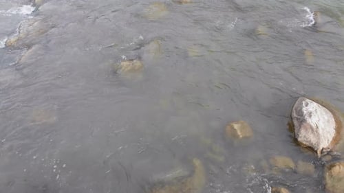 Flying Over Wild Mountain River Flowing with Stone Boulders and Rapids