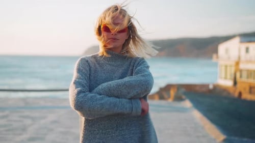 Blonde Woman Posing near the Ocean at Sunset