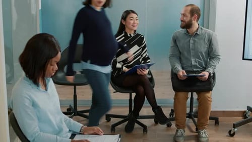 Diverse Adults Waiting in Modern Office Lobby