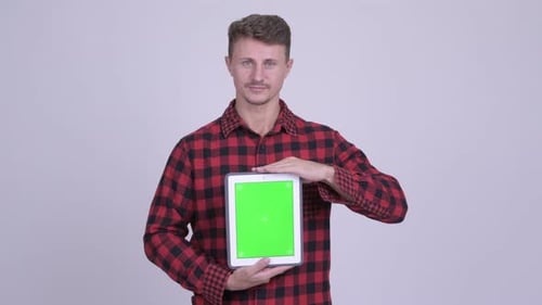 Man Presents Digital Tablet with Green Screen