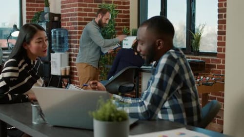 Office Workers Collaborating in a Modern Open Workplace