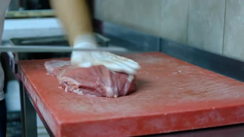 Person Preparing Raw Meat on Cutting Board