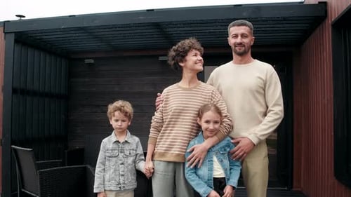 Happy Family Portrait Outside Contemporary Home