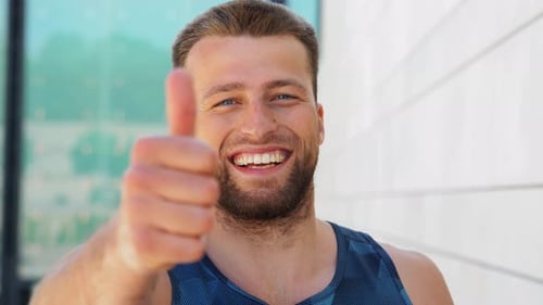 Smiling Man Gives Thumbs Up Gesture
