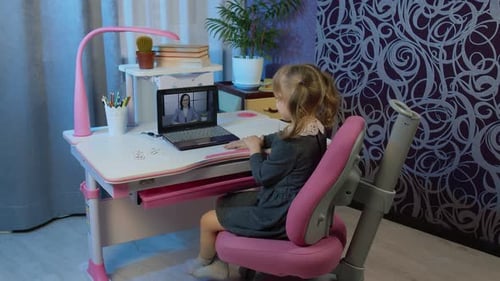 Girl Using Laptop at Desk for Online Lesson