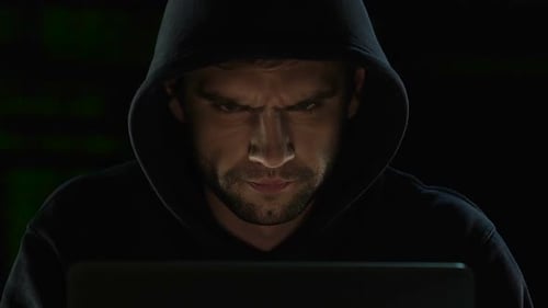 Man in Hoodie Working on Computer at Night