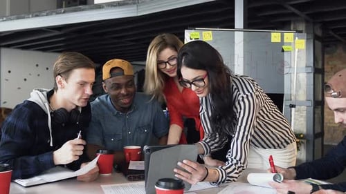 Creative Team Collaborating Around Conference Table in Office