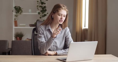 Woman Video Calling on Laptop from Home Office