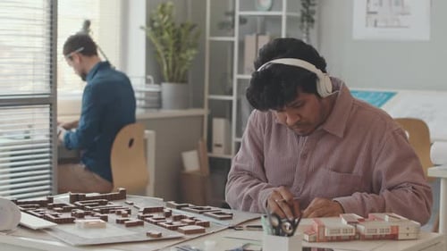 Biracial Architect Drawing Building Plan in Office