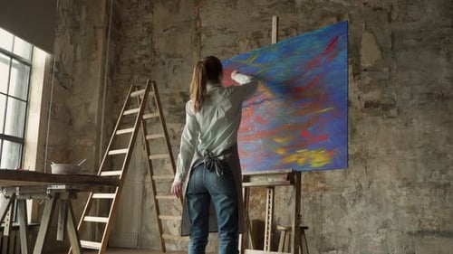 Portrait of Young Female Artist Wearing Apron in Art Studio