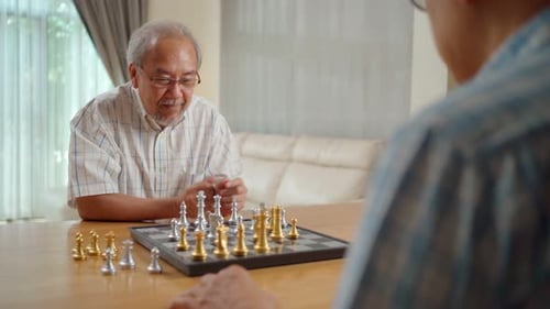 Men Playing Chess at Table Indoors
