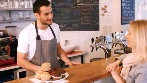 Friendly Barista Serving Coffee to Customer at Cafe