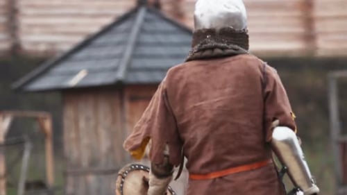 Armored Figure Walks Through Historic Recreated Village
